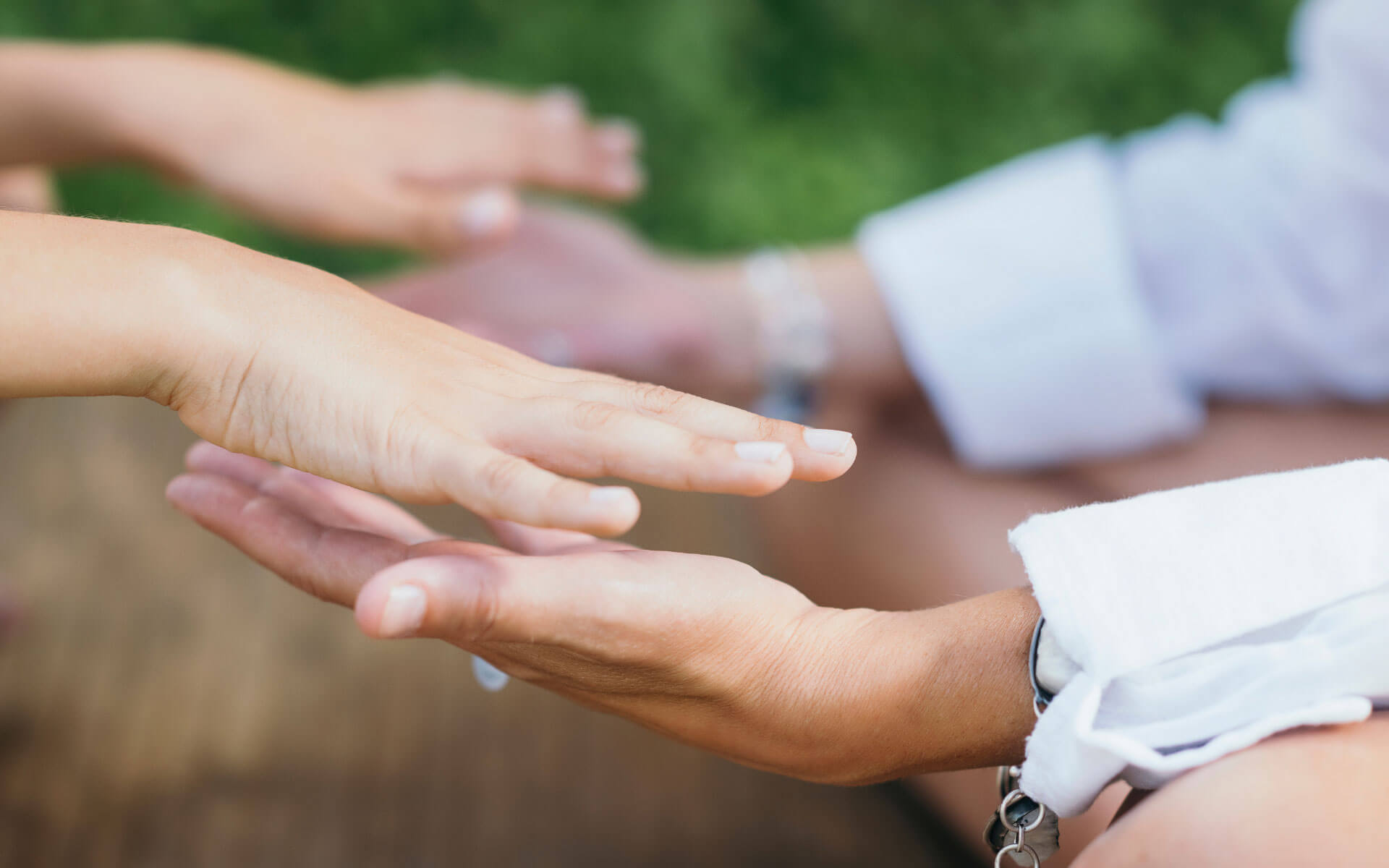 Two people sharing Reiki with each other, letting energy go from one hand to the other.