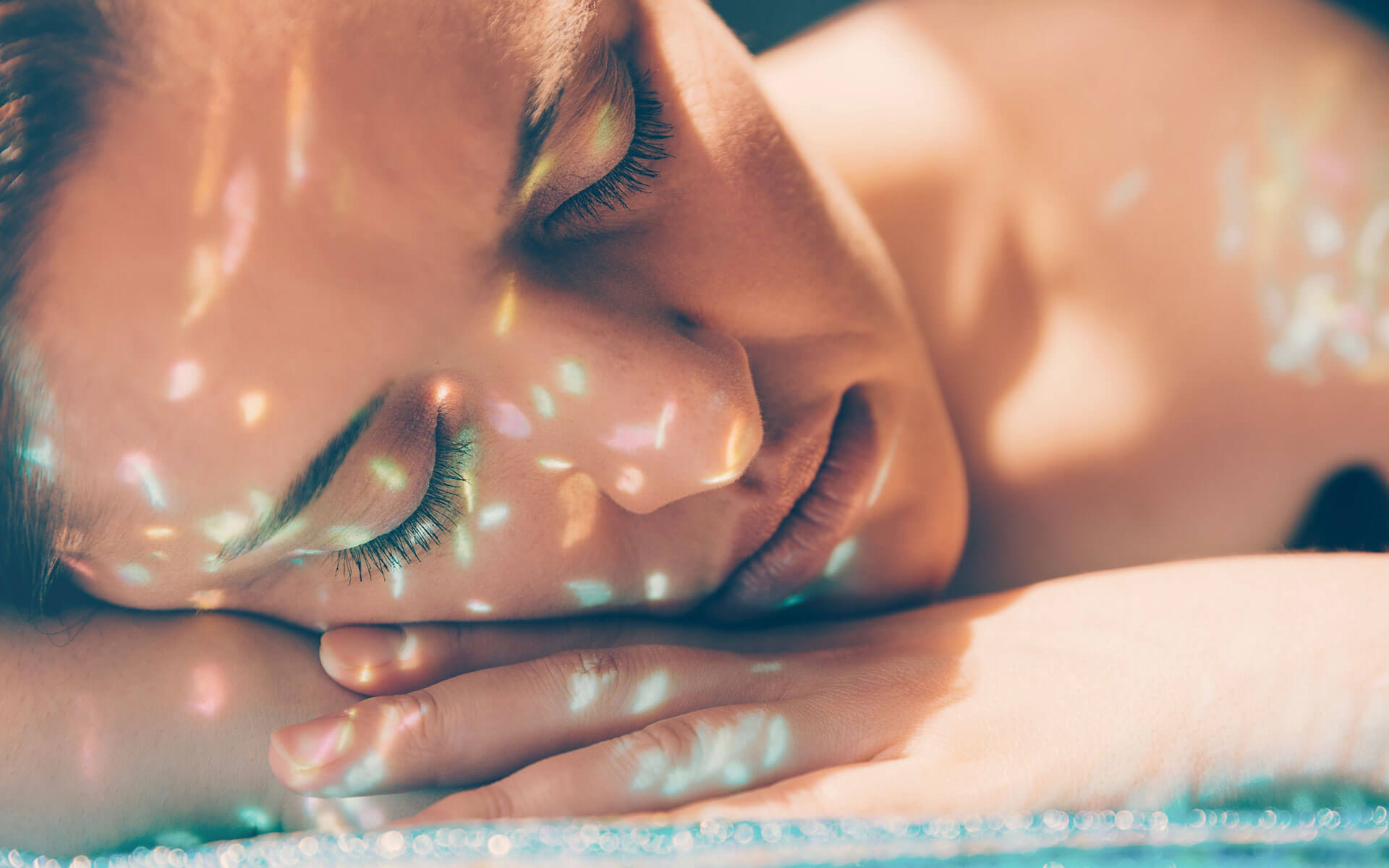 Woman receiving bright colored light, representing reiki energy